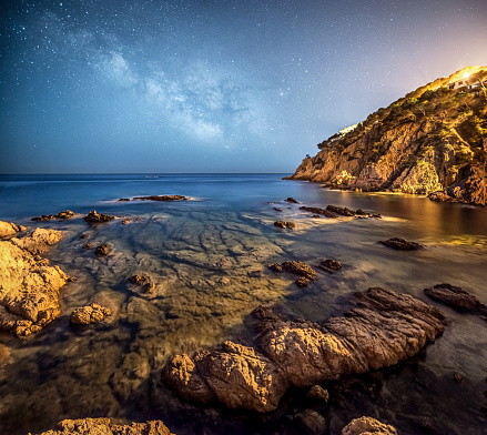 The Galactic Core of the Milky Way over the sea rocks in Costa Brava, Catalonia, Spain