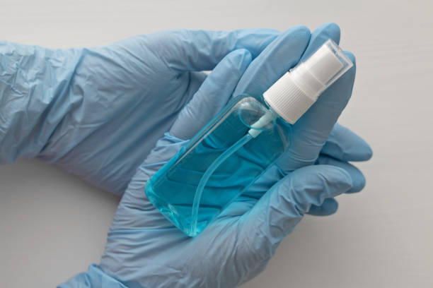 istock Sanitizer bottle in human hands 1401977992