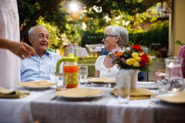 istock Two senior friends having a bonding moment during a relaxing summer dinner party 1401978164