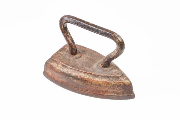 Old metal iron on old wooden blue table with old wooden wall background