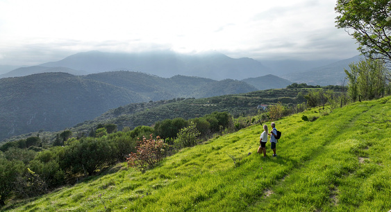 They chat as they walk through Mediterranean hillsides, on a summer morning