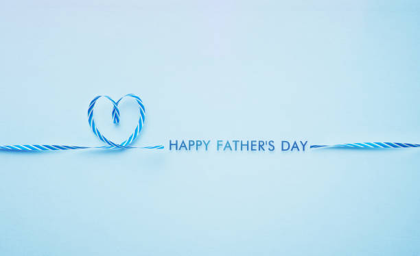 Blue striped necktie forming a heart shape on blue background. Horizontal composition with copy space. Father's Day Concept.