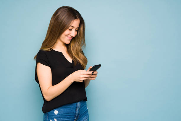 istock Young woman using her smartphone in a studio and looking happy 1401980716