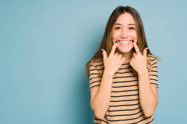 istock Cute Caucasian woman showing her beautiful smile in a studio 1401981815