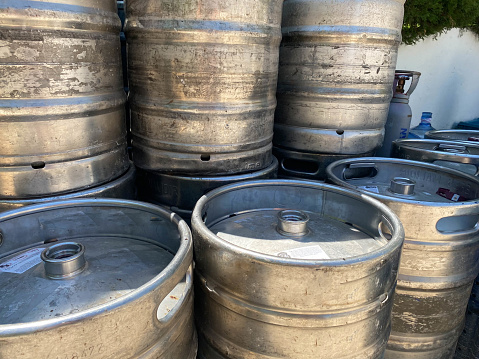 metal barrels at a construction site. large containers for liquid and bulk building materials. barrels have a black lid so as not to spill the liquid.