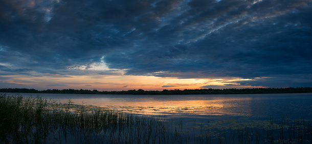 The nature of Belarus, a serene summer morning, a bright dawn on Lake Selyava