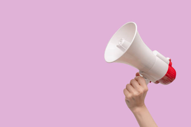 istock Megaphone in woman hands on a white background. 1401984310