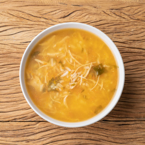 istock Chicken soup in a bowl over wooden table 1401985403