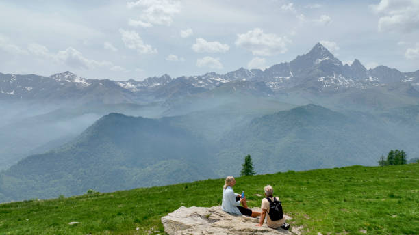istock Mature couple relax in meadow, rehydrating 1401986371