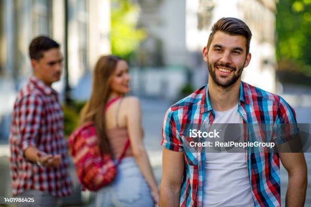 Young Woman Makes A Jealous Situation While Walking Around The City With Her Boyfriend Stock Photo - Download Image Now