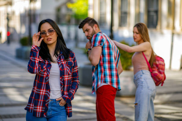 Jealous situation Disloyal man walking with his girlfriend and looking amazed at another seductive girl seduction stock pictures, royalty-free photos & images