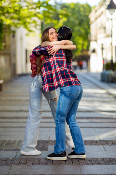 istock Two best friends are hugging on the street 1401986557
