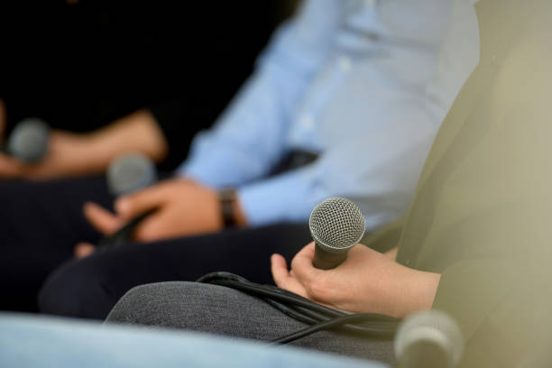 Audience with microphones at the panel discussion