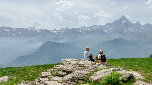 istock Mature couple relax in meadow, rehydrating 1401986646