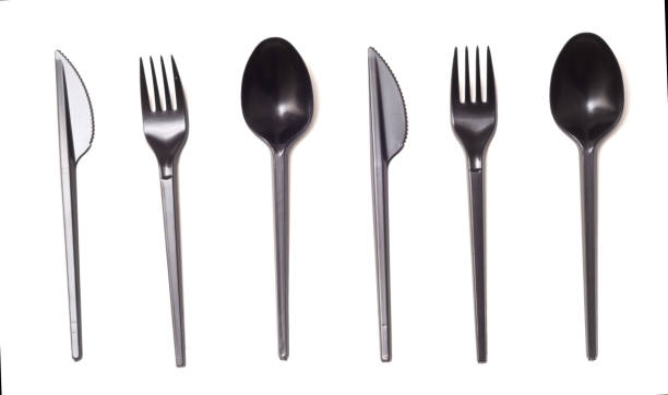 istock Repeating black plastic disposable knife,spoon and fork isolated on white, top view. 1401991402