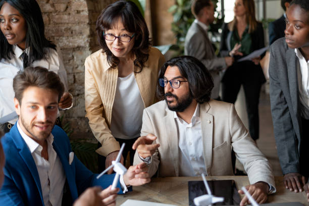 istock Group of engineers , specializing in renewable energy plants, discussing by a new project. 1401991699