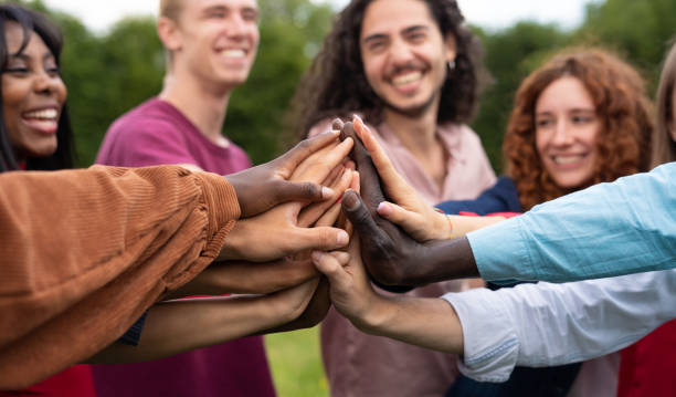 istock Multiracial happy young people shaking hands - University students celebrating a International Volunteer Day 1401991986