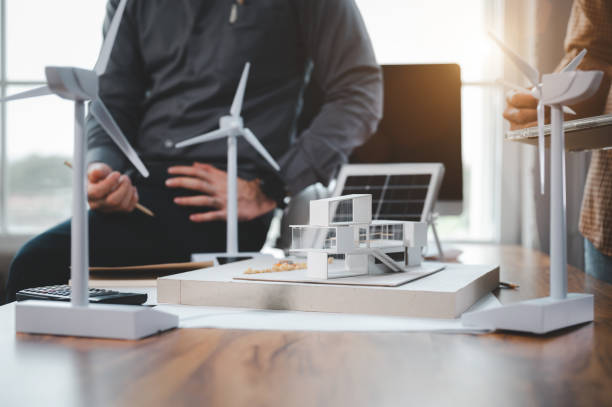 istock Two engineer design professionals discussion about calculate to use pure energy nature and Installing solar panels on roof house to generate electricity working with model, and Solar panel sample 1401993111