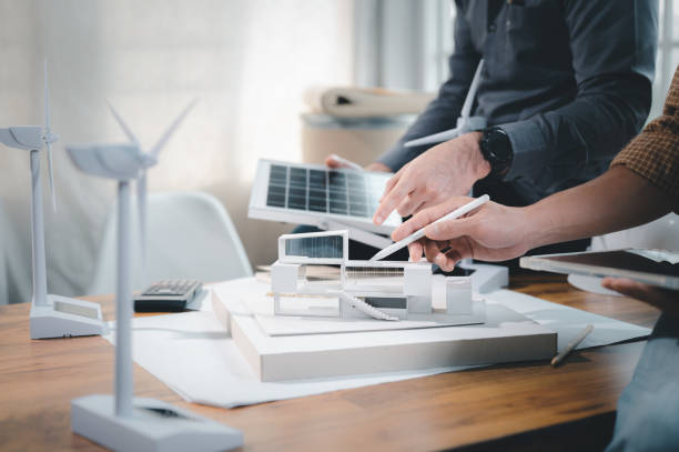 istock Two engineer design professionals discussion about calculate to use pure energy nature and Installing solar panels on roof house to generate electricity working with model, and Solar panel sample 1401993140