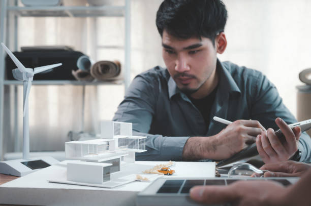 istock Engineers specializing in design and computing to power pure energy in modern homes. save energy in the future with Solar panel samples. Selection focus shooting on home model 1401993174