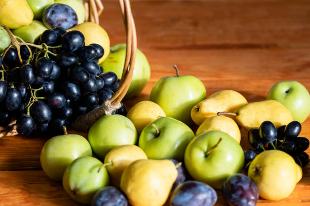 Close-up snow pear fruit, fresh Nashi or Korean pear fruit. Selective focus. Vegetarian, healthy diet food. Autumn harvest concept. Natural blur background. Preparing meal at home, fruit salad