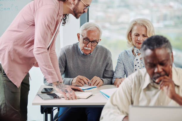 istock Small multiracial group of senior students in a classroom asking for explanation their teacher. 1401995501