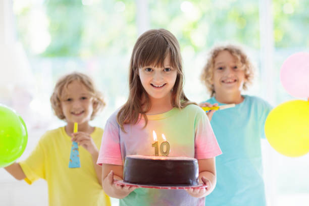 kids birthday party. child blowing out cake candle - pastry cutter family holiday child imagens e fotografias de stock