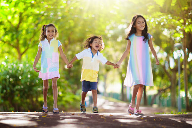 istock Happy kids play in summer park. 1401995567