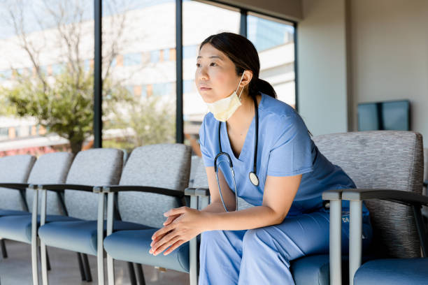 istock Tired female doctor meditates or prays between surgeries 1401996436