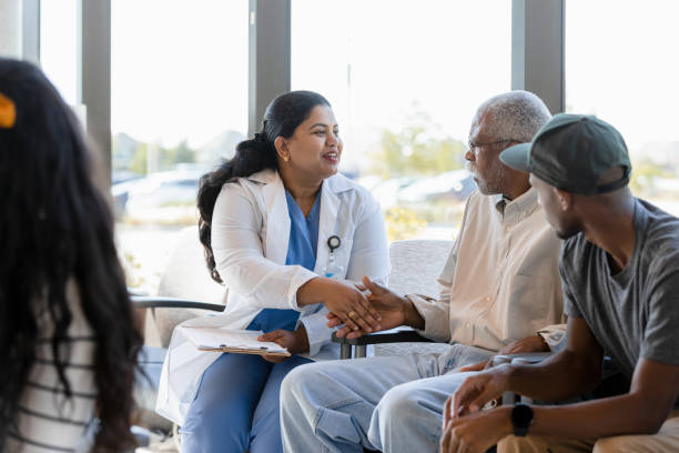 female doctor greets senior patient with handshake - outpatient imagens e fotografias de stock