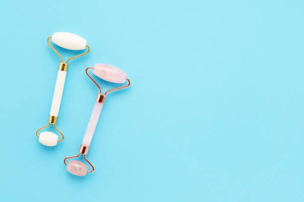 istock Set of two massage rollers for face on light blue background. Selfcare, skincare concept 1402000426