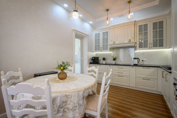 istock Modern white large luxurious kitchen and dining room in studio apartment 1402002805