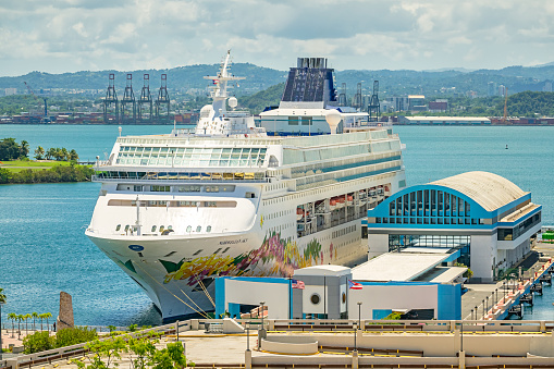 A cruise ship is docked at the San Juan harbor, Puerto Rico on a sunny day.