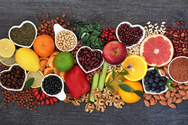 Healthy Heart Food High In Flavonoids and Polyphenols Healthy heart food high in flavonoids, polyphenols, antioxidants, anthocyanins, lycopene, vitamins, proteins, bioflavonoids, minerals, fibre. On rustic wood background. dietary fiber stock pictures, royalty-free photos & images