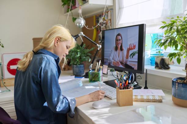istock Teenage girl studying at home online using computer 1402007329