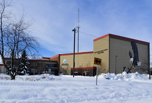 Anchorage, Alaska, USA: West Anchorage High School and auditorium, home to the West Anchorage Eagles football team - Hillcrest Drive with snow.