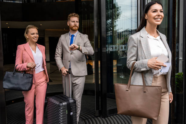 istock Three colleagues seen leaving a hotel after luxury business experience 1402012590