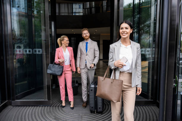 istock Three colleagues seen leaving a hotel after luxury business experience 1402012604