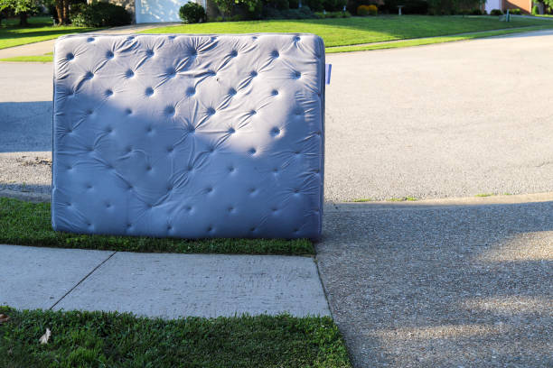 Old mattress sitting outside on the sidewalk stock photo