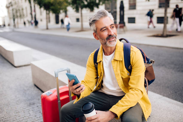 istock Mature tourist taking a coffee break and texting 1402021295