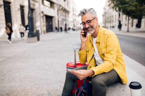 istock Mature tourist taking a coffee break and shopping online 1402021297
