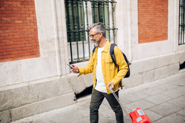 istock Mature man arriving to Madrid and using GPS for sightseeing 1402021311