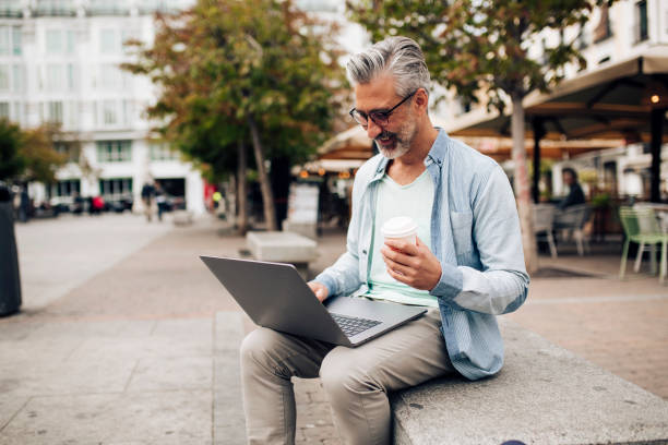 istock Man on vacation taking a break for coffee and surfing the net 1402021329