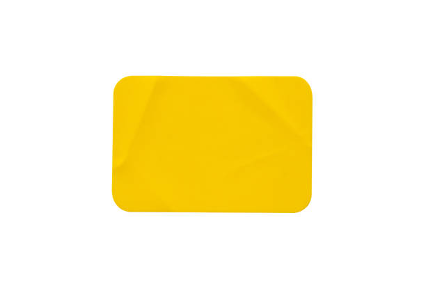 istock Yellow plastic sticker label isolated on white background 1402021359