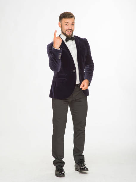 istock cheerful man in a jacket with a bow tie posing isolated on a light background 1402022750