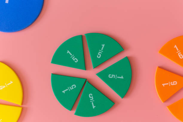 istock Multicolored fractions, on pink background. Interesting, fun math for kids. Education, back to school concept 1402023145