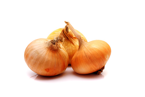 Three flat onion bulbs isolated on white background