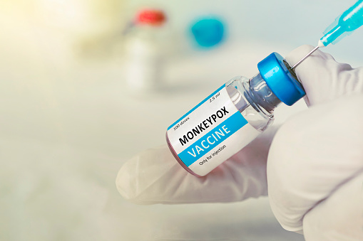 Vacunación para la vacuna de refuerzo para la viruela y la viruela del mono MPXV. Médico con vial de la vacuna de rosas para la enfermedad de la viruela del mono photo