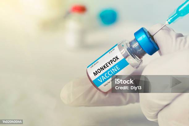 Vaccination For Booster Shot For Smallpox And Monkeypox Mpxv Doctor With Vial Of Roses Vaccine For Monkeypox Disease Stock Photo - Download Image Now