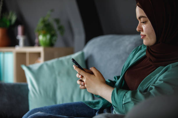 istock Young woman resting on the sofa and scrolling through social media 1402045557